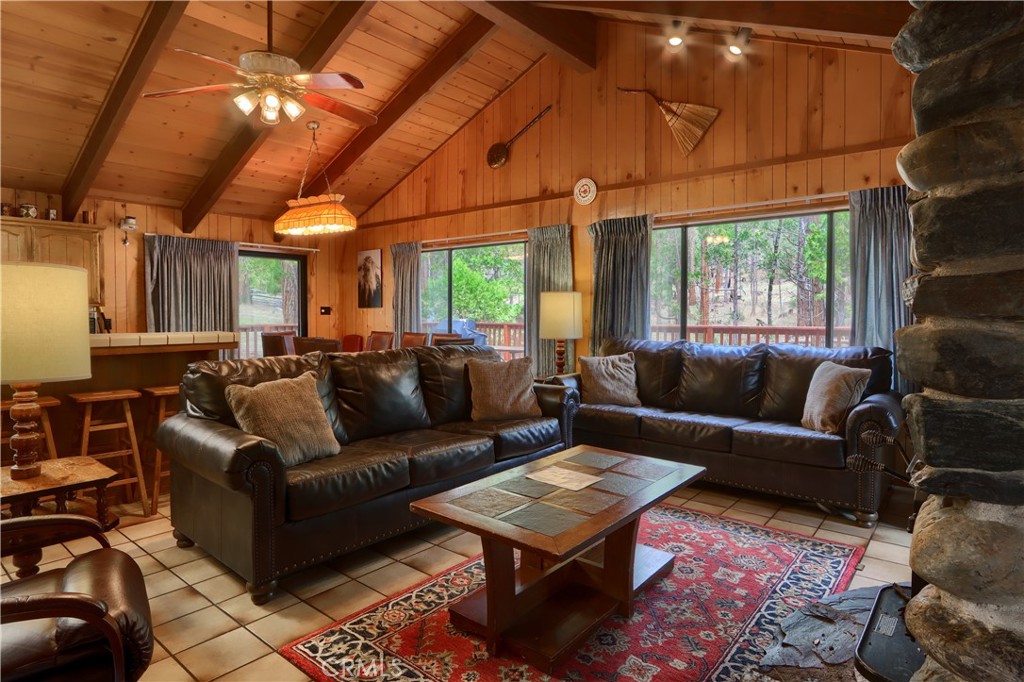 8041 Chilnualna Falls Road Wawona, CA 95389 - Photo 3 of 46 a living room with furniture a ceiling fan and a window