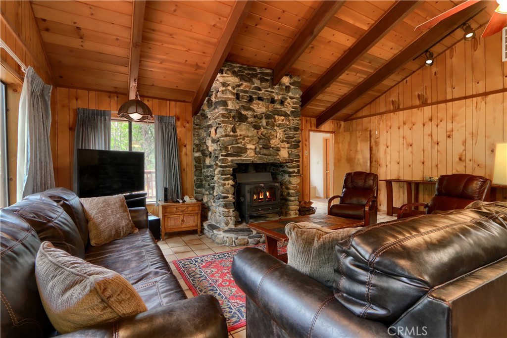 8041 Chilnualna Falls Road Wawona, CA 95389 - Photo 4 of 46 a living room with furniture a fireplace and a flat screen tv