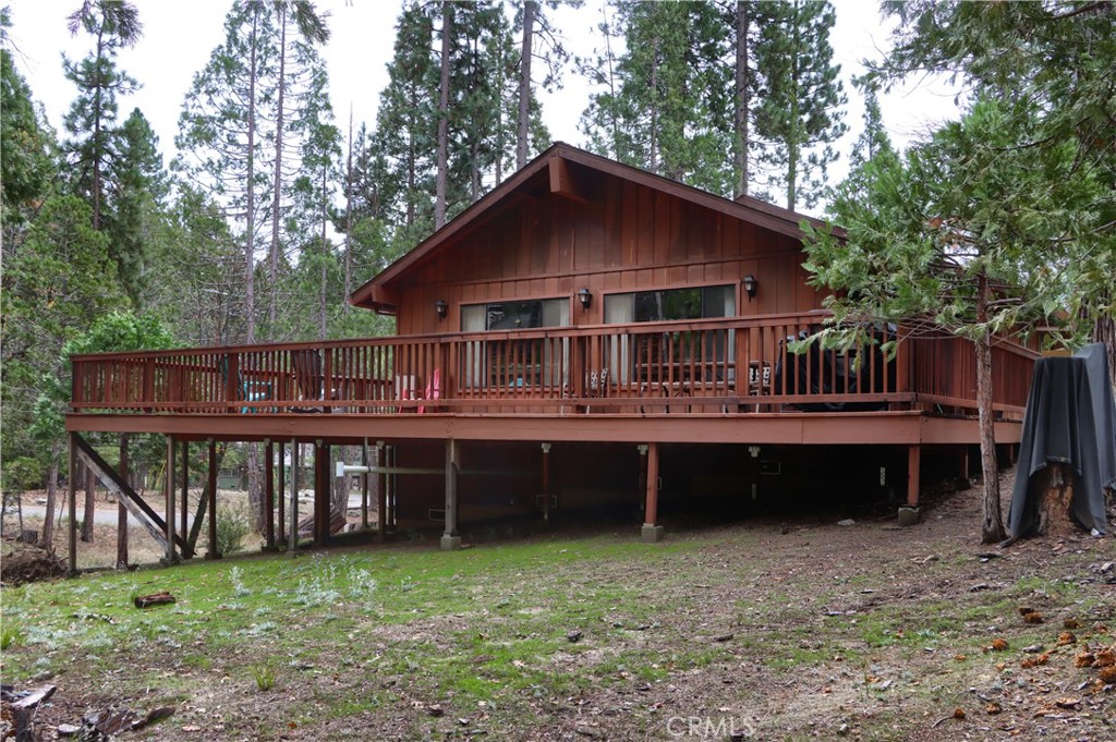 8041 Chilnualna Falls Road Wawona, CA 95389 - Photo 42 of 46 a view of a house with a deck and a yard with a large tree