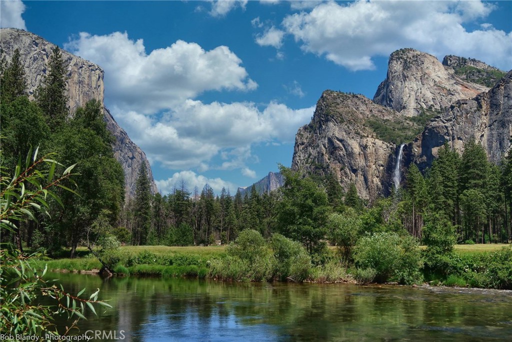 8041 Chilnualna Falls Road Wawona, CA 95389 - Photo 44 of 46 a view of a lake with a building in the background