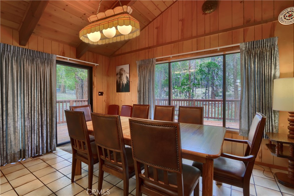 8041 Chilnualna Falls Road Wawona, CA 95389 - Photo 7 of 46 a view of a dining room with furniture large windows and wooden floor