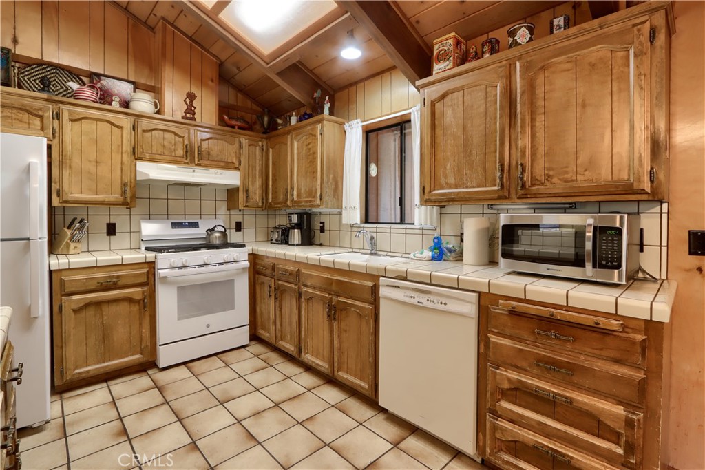 8041 Chilnualna Falls Road Wawona, CA 95389 - Photo 10 of 46 a kitchen with cabinets appliances a sink and a window