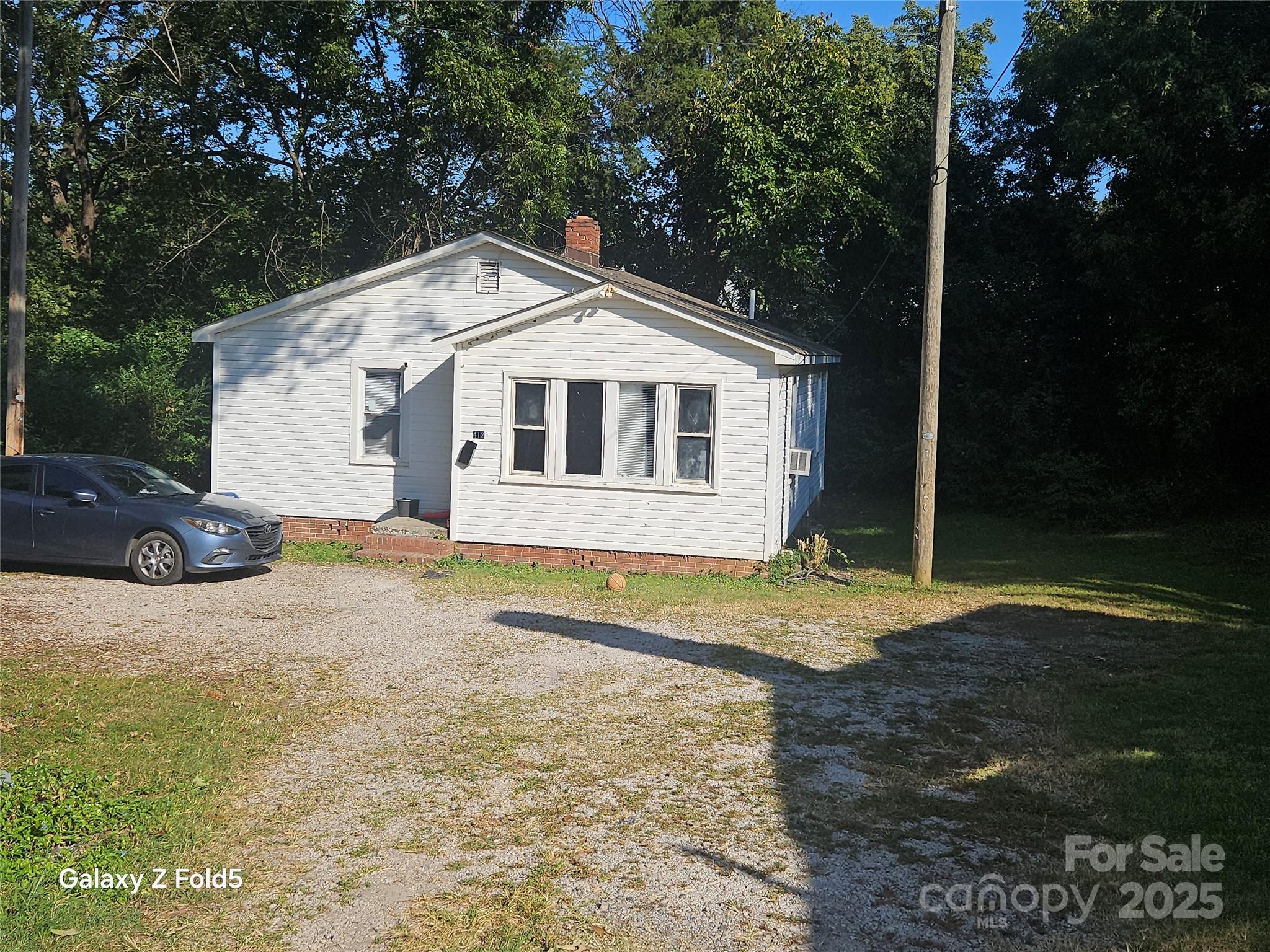 412 Fewell Street Rock Hill, SC 29730 - Photo 2 of 9 a view of a white house next to a yard with large trees