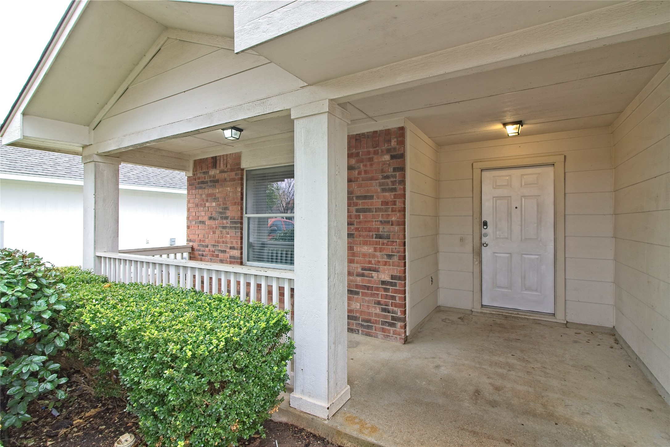 232 Brickyard Lane Jarrell, TX 76537 - Photo 4 of 31 A welcoming covered porch with classic brick accents and crisp white railing awaits.