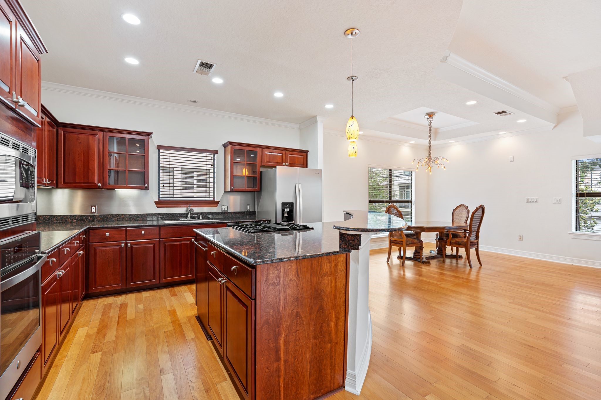 501 Detering Street Houston, TX 77007 - Photo 5 of 44 a kitchen with a table chairs stove and wooden floor