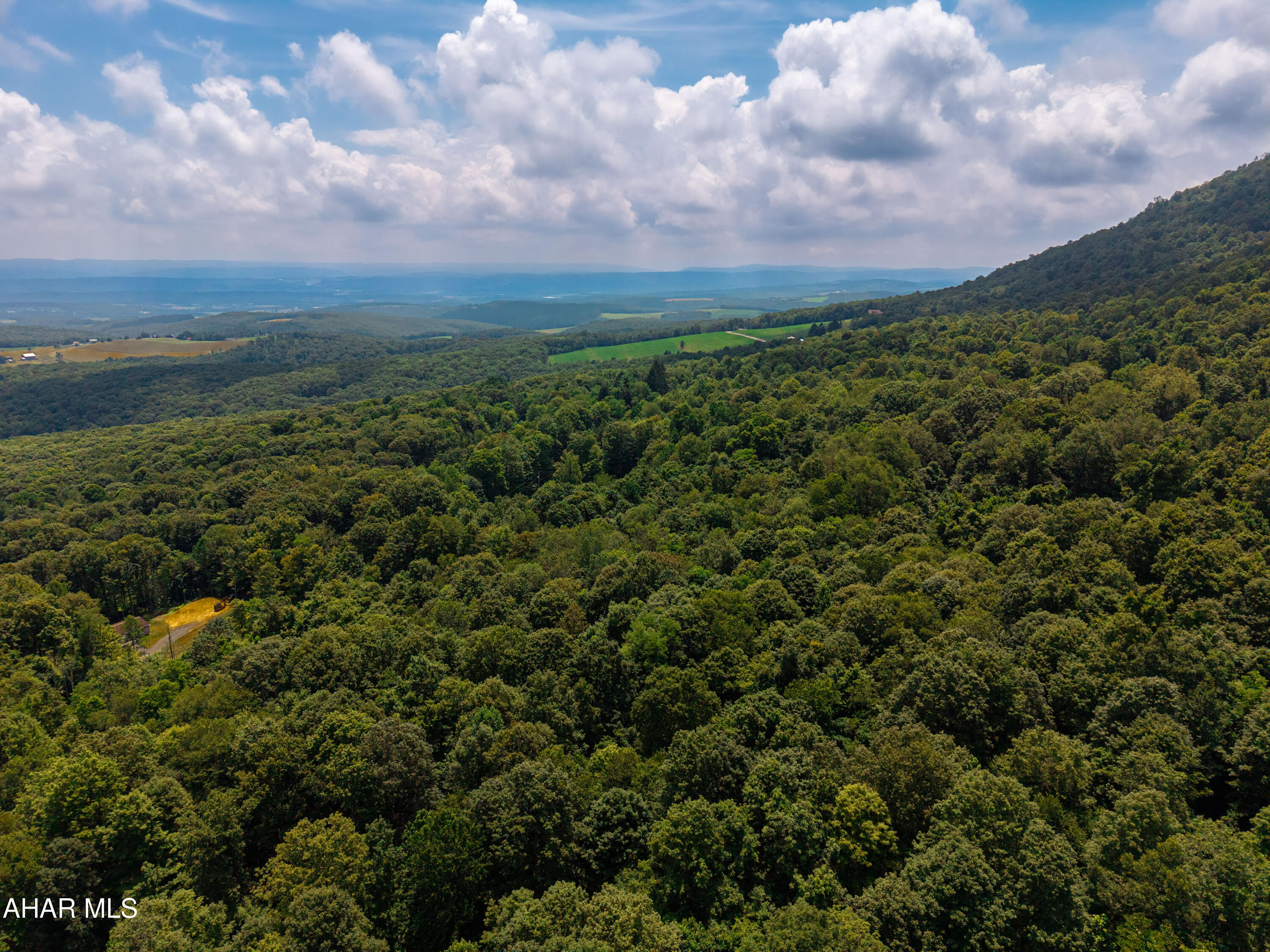 Off Mountain View Drive Schellsburg, PA 15559 - Photo 7 of 11 a view of a city with lush green forest