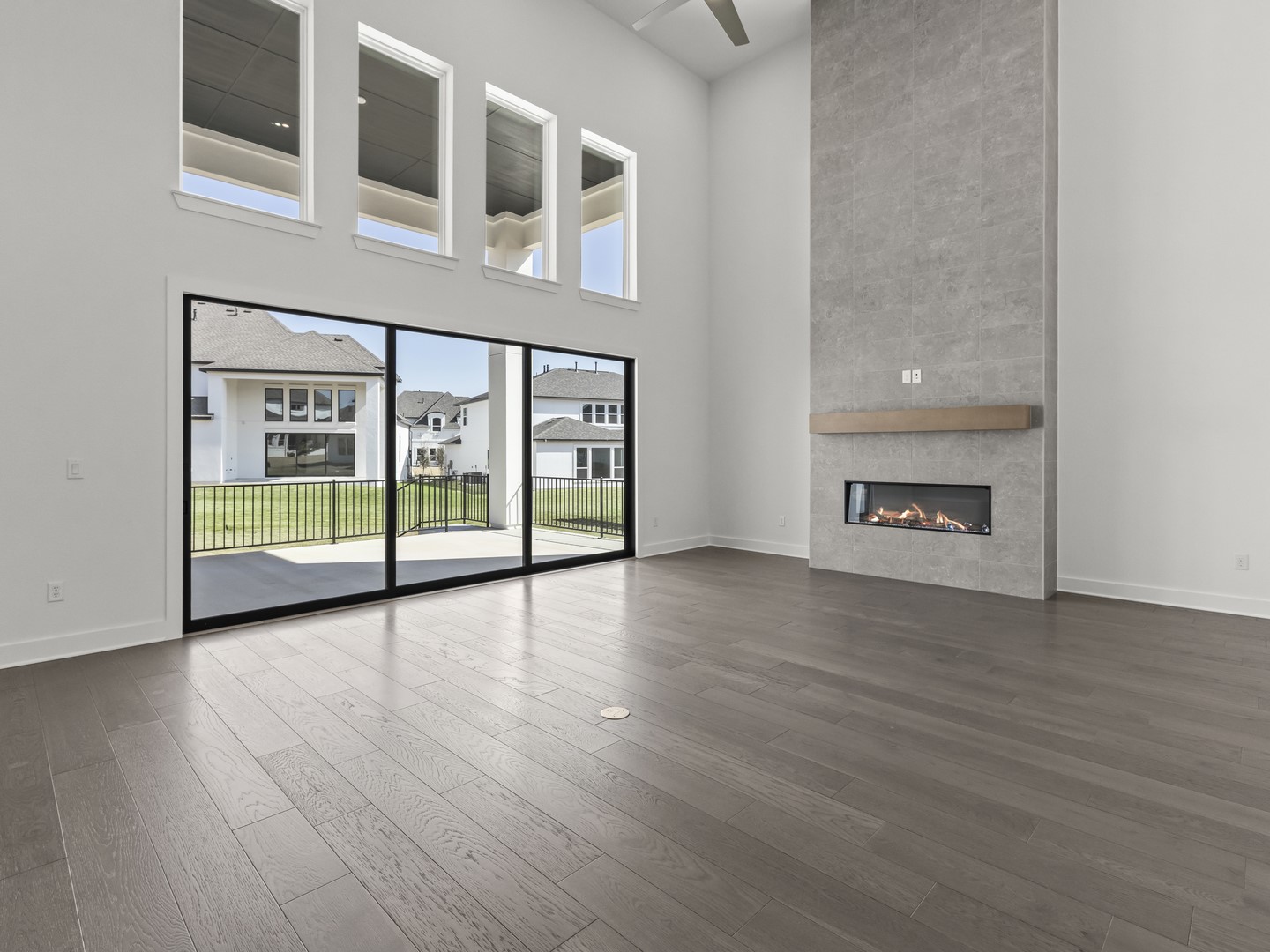 2508 Chiavari Way Leander, TX 78641 - Photo 4 of 24 Floor-to-ceiling windows and a gas fireplace define this elegant living space.