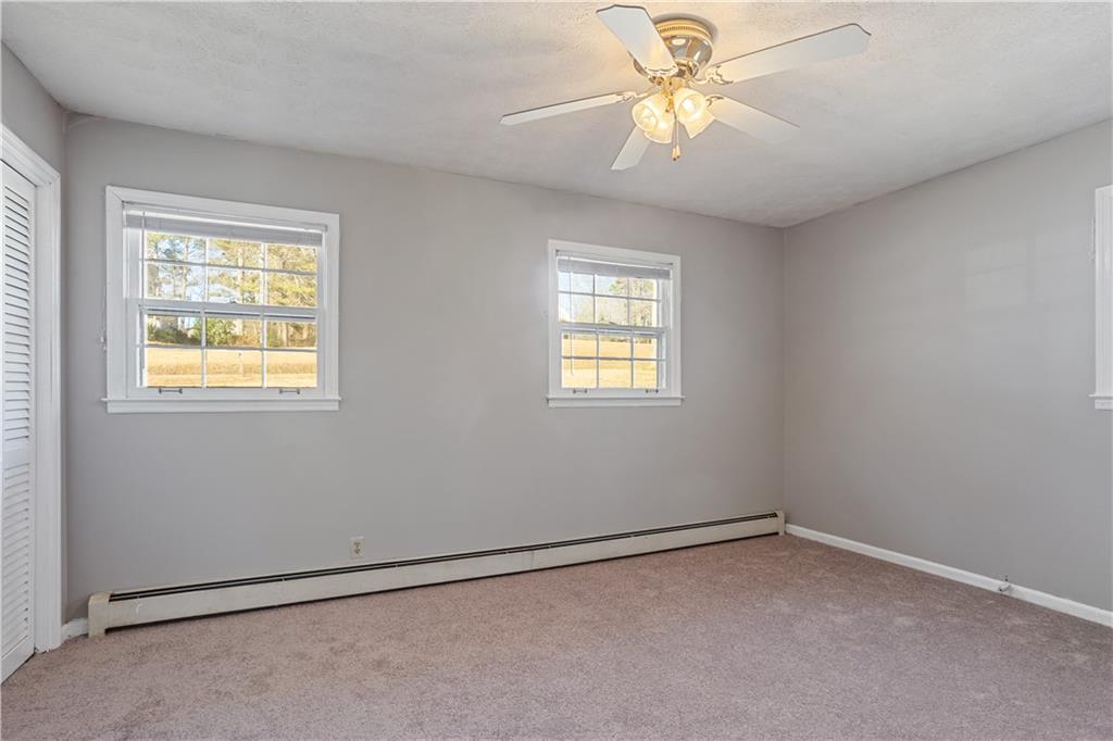 1021 Palm Street Canton, GA 30115 - Photo 11 of 31 an empty room with a window and a fan