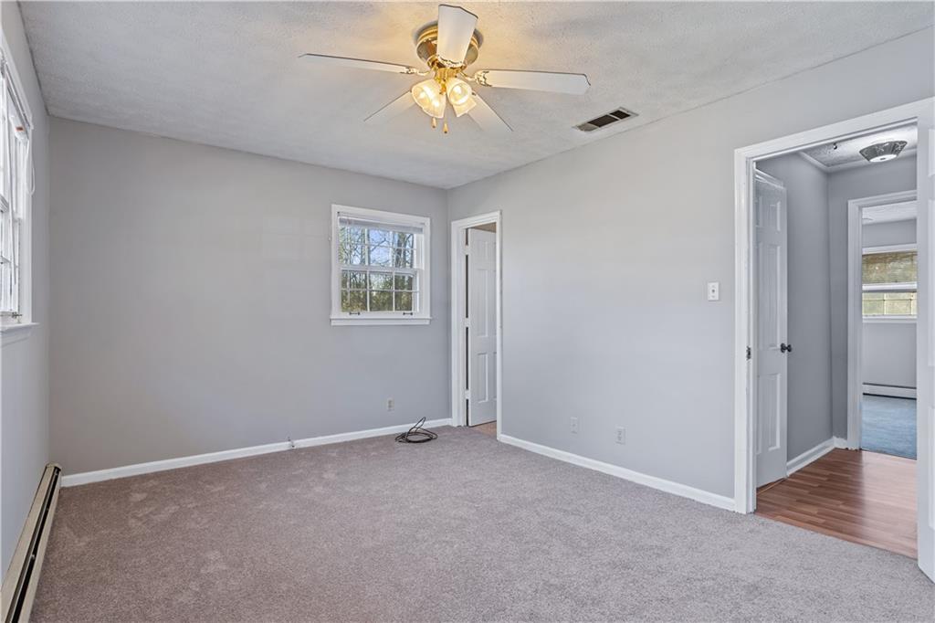 1021 Palm Street Canton, GA 30115 - Photo 12 of 31 an empty room with closet and a chandelier fan