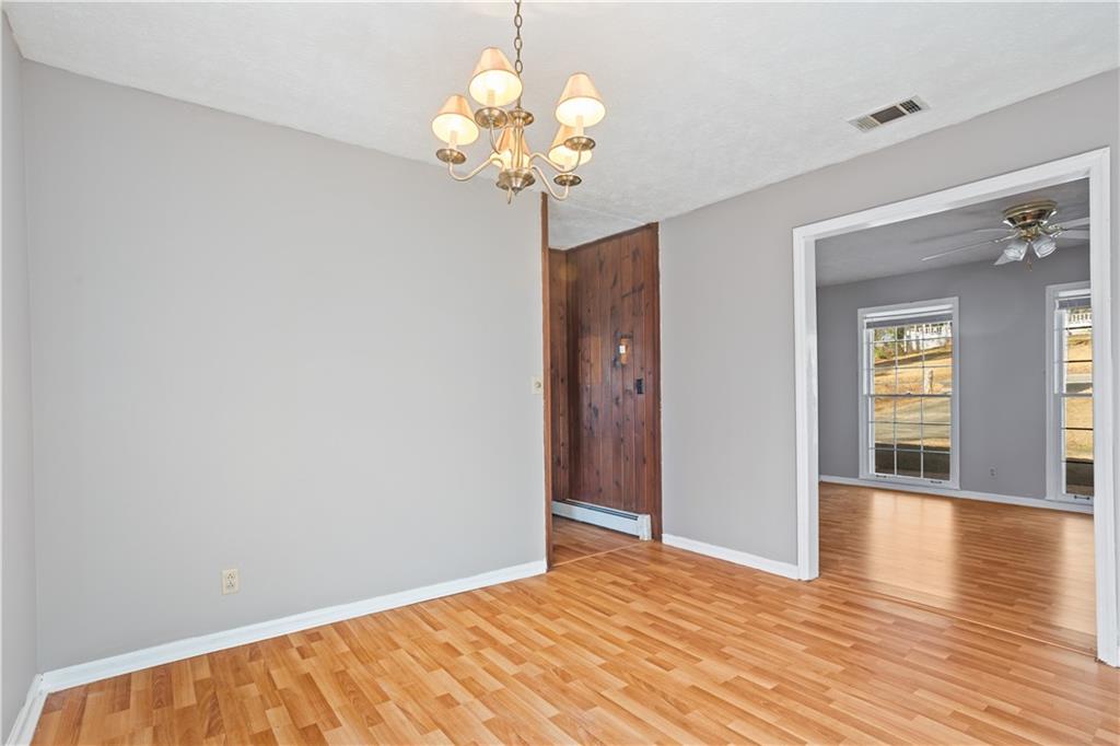 1021 Palm Street Canton, GA 30115 - Photo 16 of 31 a view of an empty room with wooden floor and potted plant