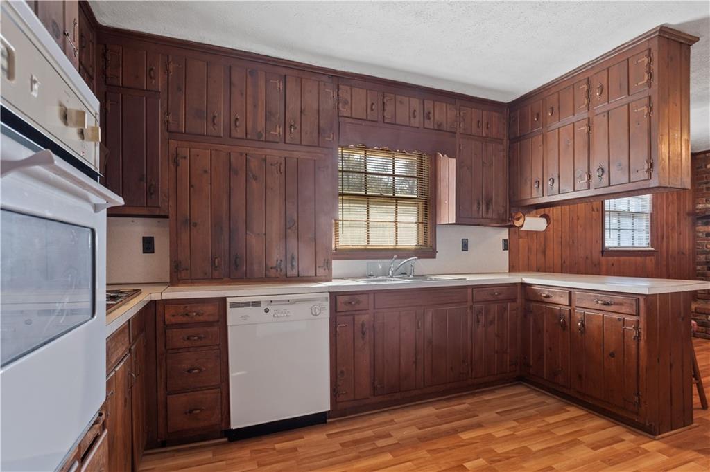 1021 Palm Street Canton, GA 30115 - Photo 17 of 31 a kitchen with granite countertop wooden cabinets stainless steel appliances a sink and a window