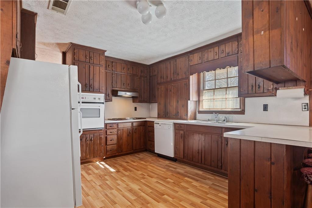 1021 Palm Street Canton, GA 30115 - Photo 18 of 31 a kitchen with stainless steel appliances granite countertop a stove a sink dishwasher and a refrigerator
