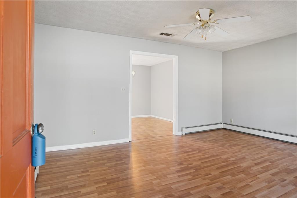 1021 Palm Street Canton, GA 30115 - Photo 2 of 31 a view of an empty room with wooden floor
