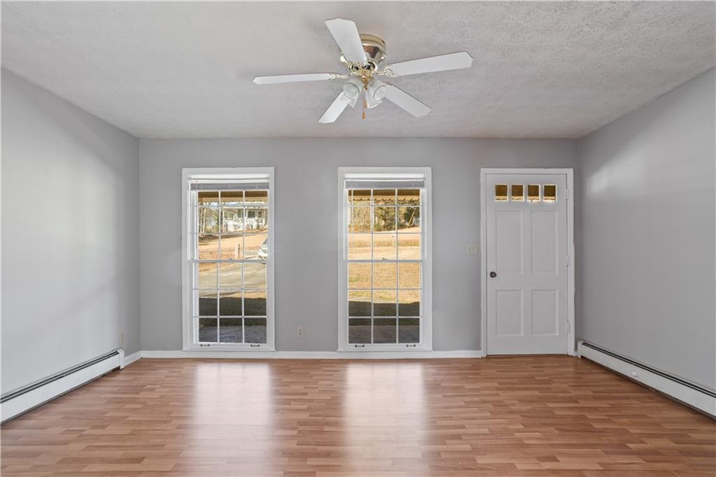 1021 Palm Street Canton, GA 30115 - Photo 3 of 31 a view of an empty room with wooden floor and a window