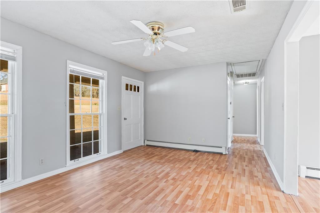 1021 Palm Street Canton, GA 30115 - Photo 5 of 31 a view of an empty room with wooden floor and a window