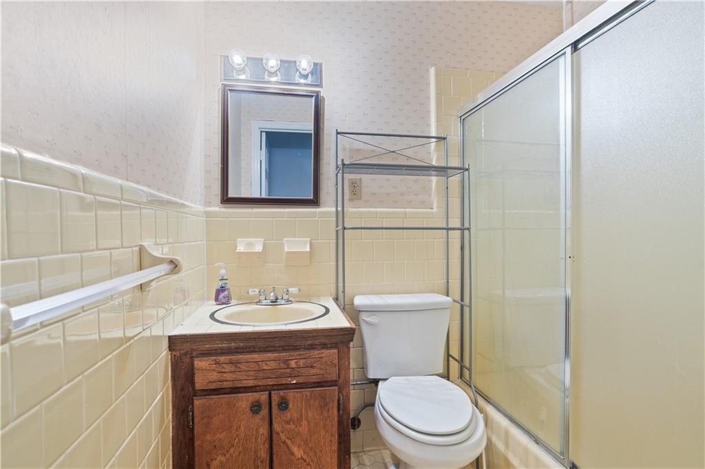 1021 Palm Street Canton, GA 30115 - Photo 9 of 31 a bathroom with a toilet a sink and mirror