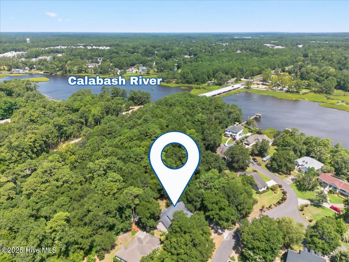 8985 Woodbine Road Southwest Sunset Beach, NC 28468 - Photo 64 of 65 Drone aerial view of the home and the Calabash River