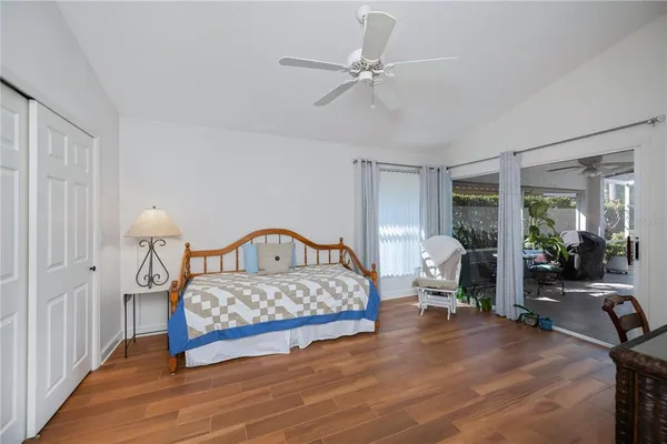 a bedroom with a bed and wooden floor