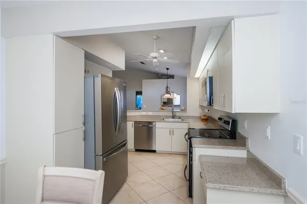 a kitchen with kitchen island a sink stainless steel appliances and cabinets