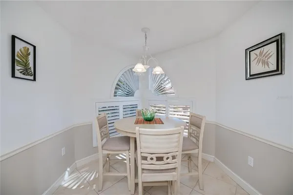 a view of a dining room with furniture and a chandelier