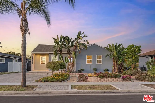 a front view of a house with a garden