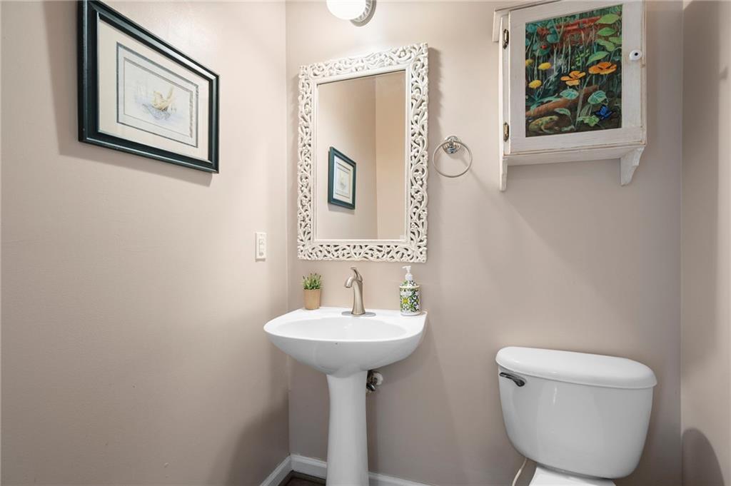 202 Reserve Crossing Canton, GA 30115 - Photo 12 of 56 a bathroom with a toilet a sink and mirror