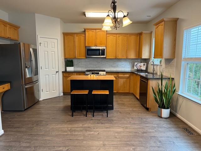 202 Reserve Crossing Canton, GA 30115 - Photo 19 of 56 a kitchen with stainless steel appliances granite countertop a stove refrigerator and microwave
