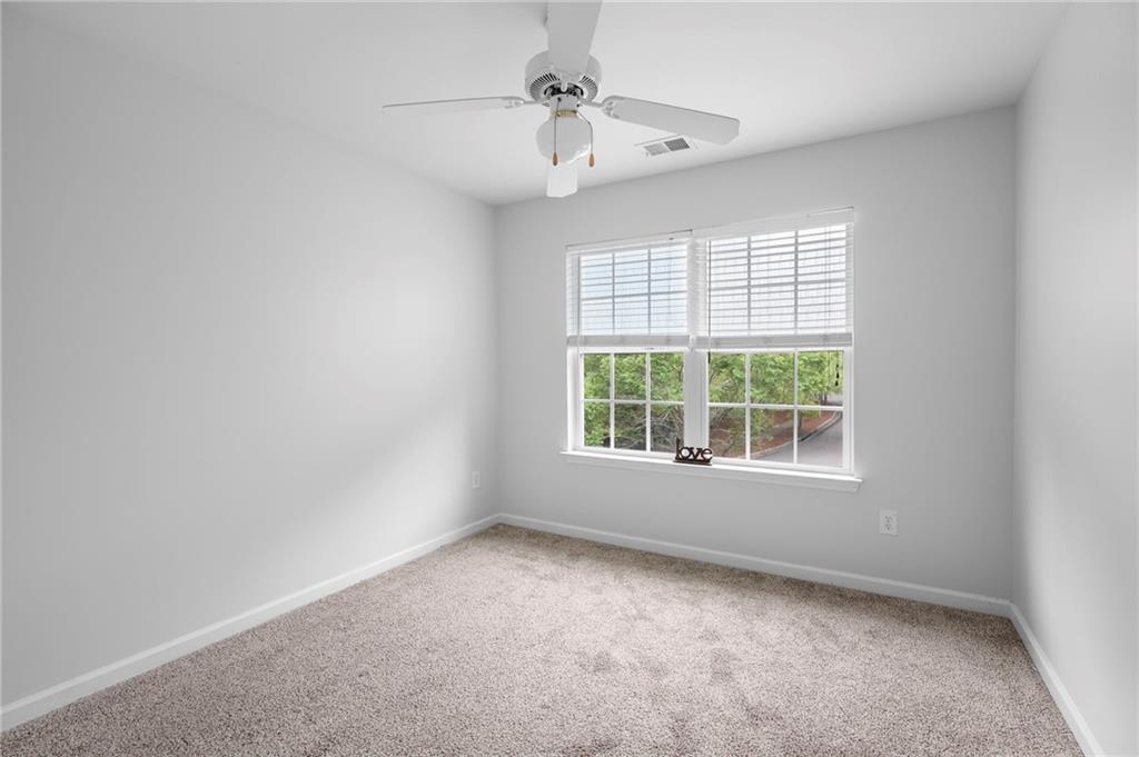 202 Reserve Crossing Canton, GA 30115 - Photo 26 of 56 an empty room with a window and a fan