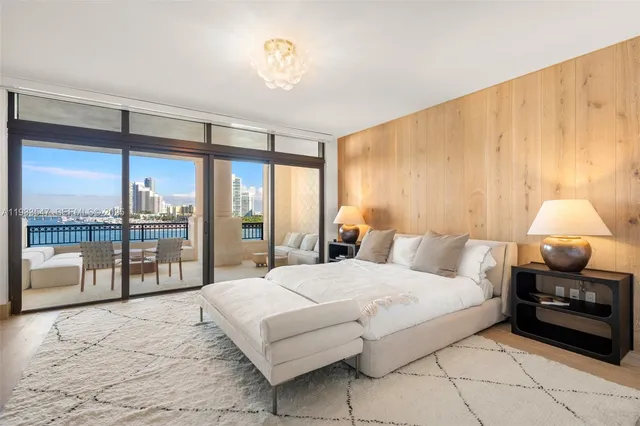 a dining room with furniture and a floor to ceiling window