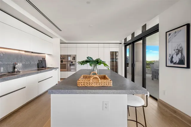 a living room with furniture a window and a potted plant