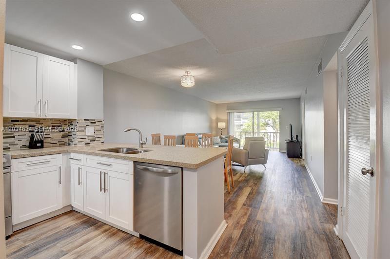 9880 Marina Boulevard, Unit 1516 Boca Raton, FL 33428 - Photo 4 of 32 a kitchen with cabinets a sink and appliances
