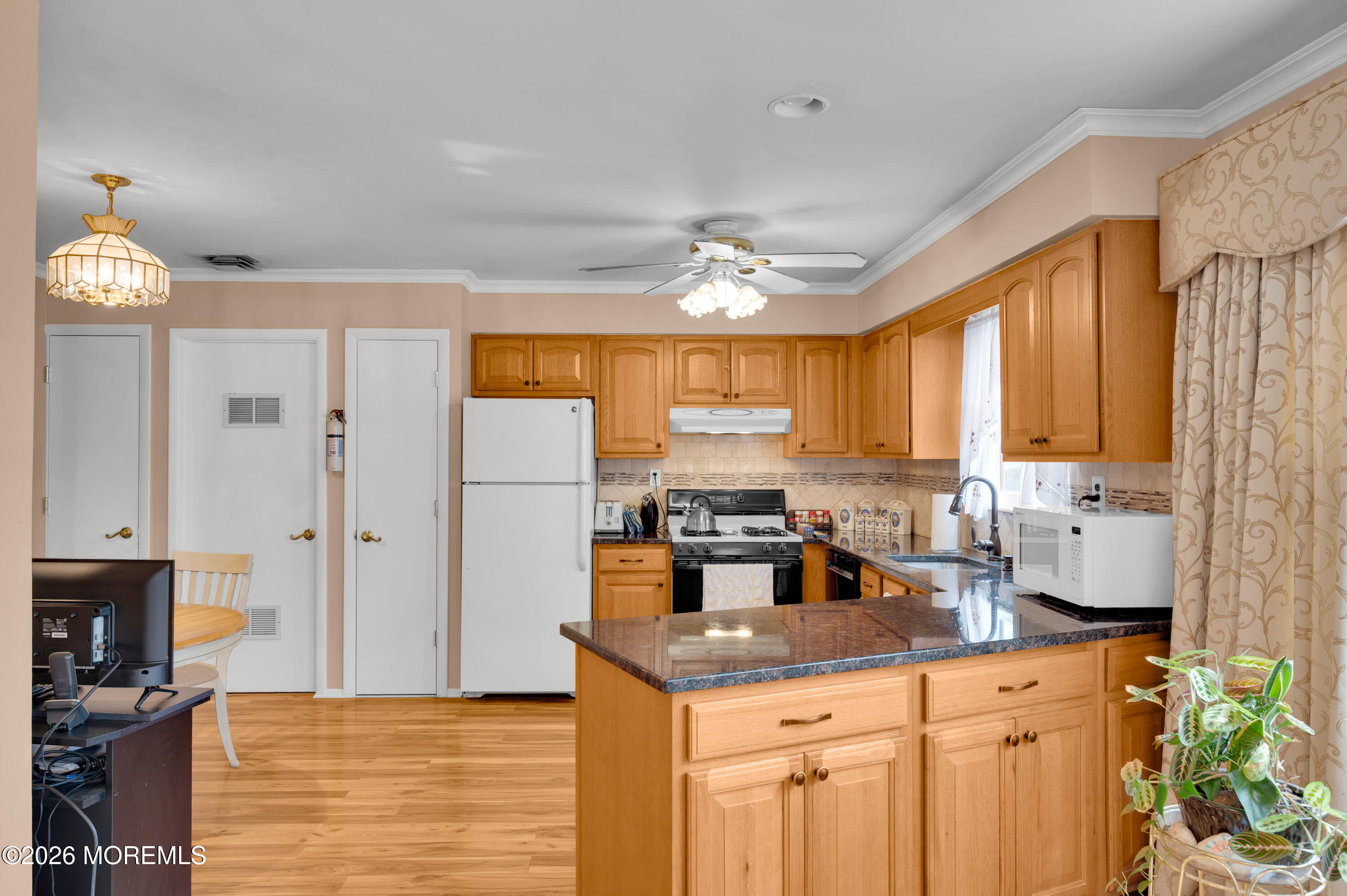 46 Baser Lane Brick, NJ 08724 - Photo 13 of 31 a kitchen with stainless steel appliances granite countertop a stove a sink dishwasher and a refrigerator with wooden floor
