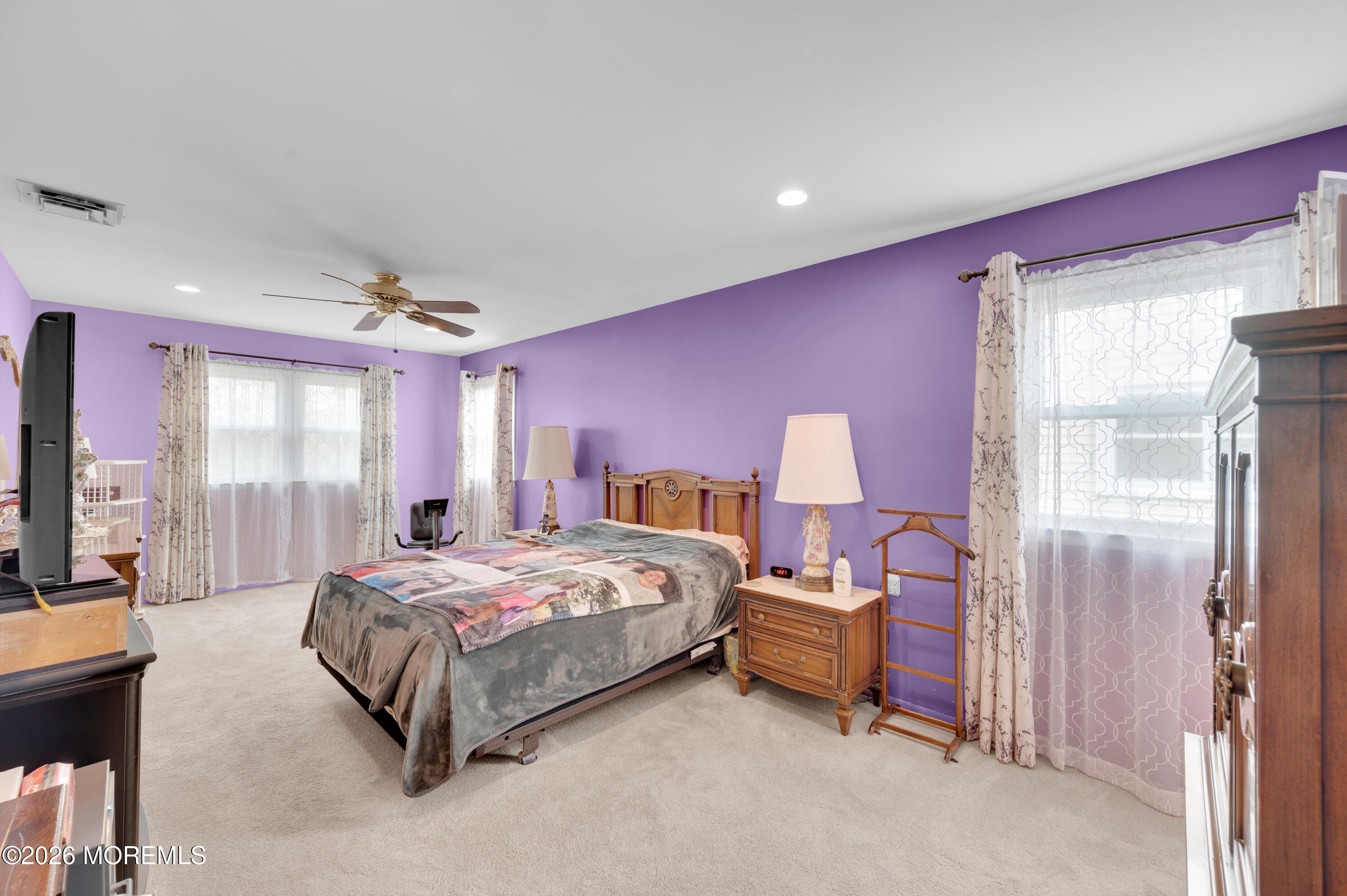46 Baser Lane Brick, NJ 08724 - Photo 19 of 31 a spacious bedroom with a bed and a flat screen tv