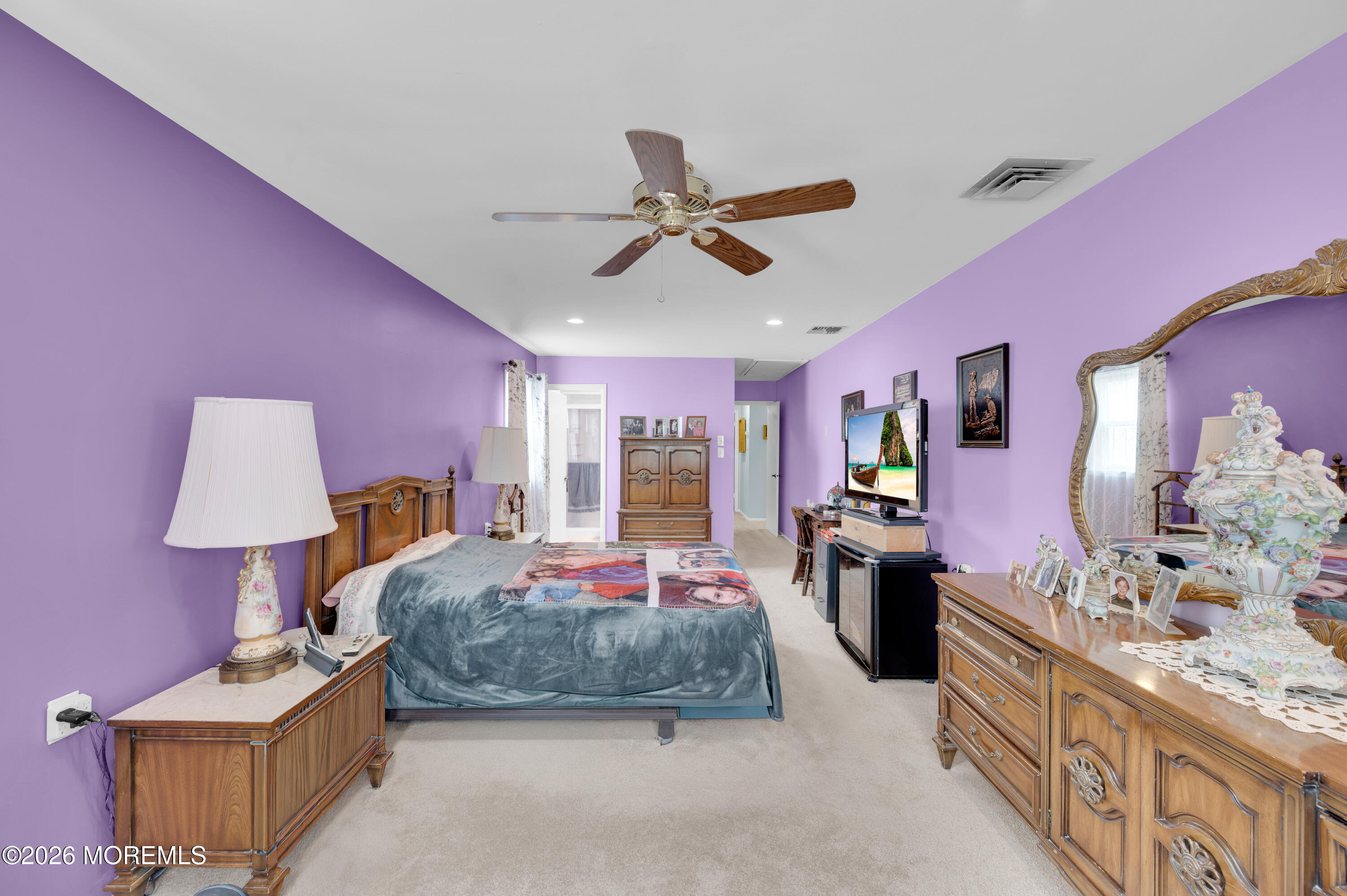 46 Baser Lane Brick, NJ 08724 - Photo 20 of 31 a spacious bedroom with a bed and a chandelier