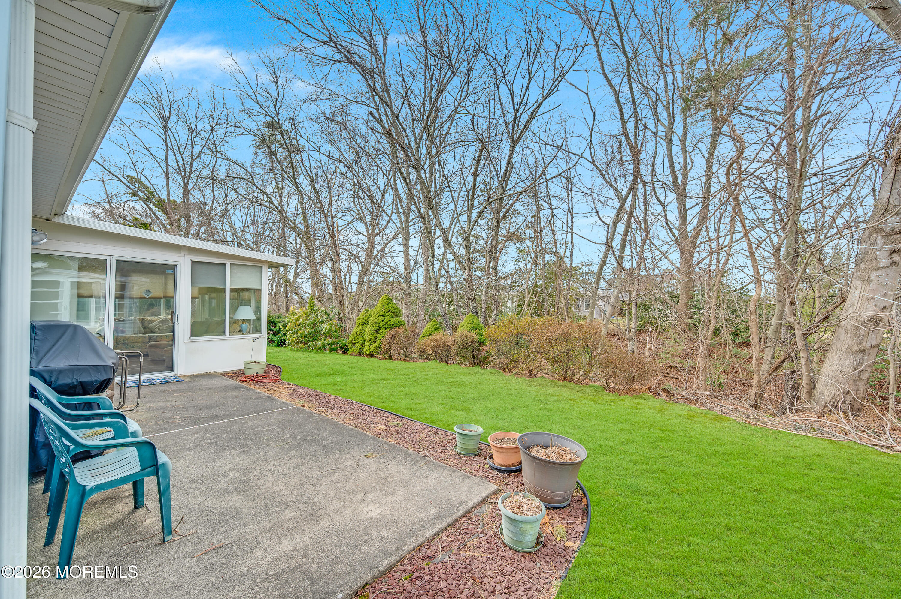 46 Baser Lane Brick, NJ 08724 - Photo 27 of 31 a view of a backyard with chairs potted plants and large tree