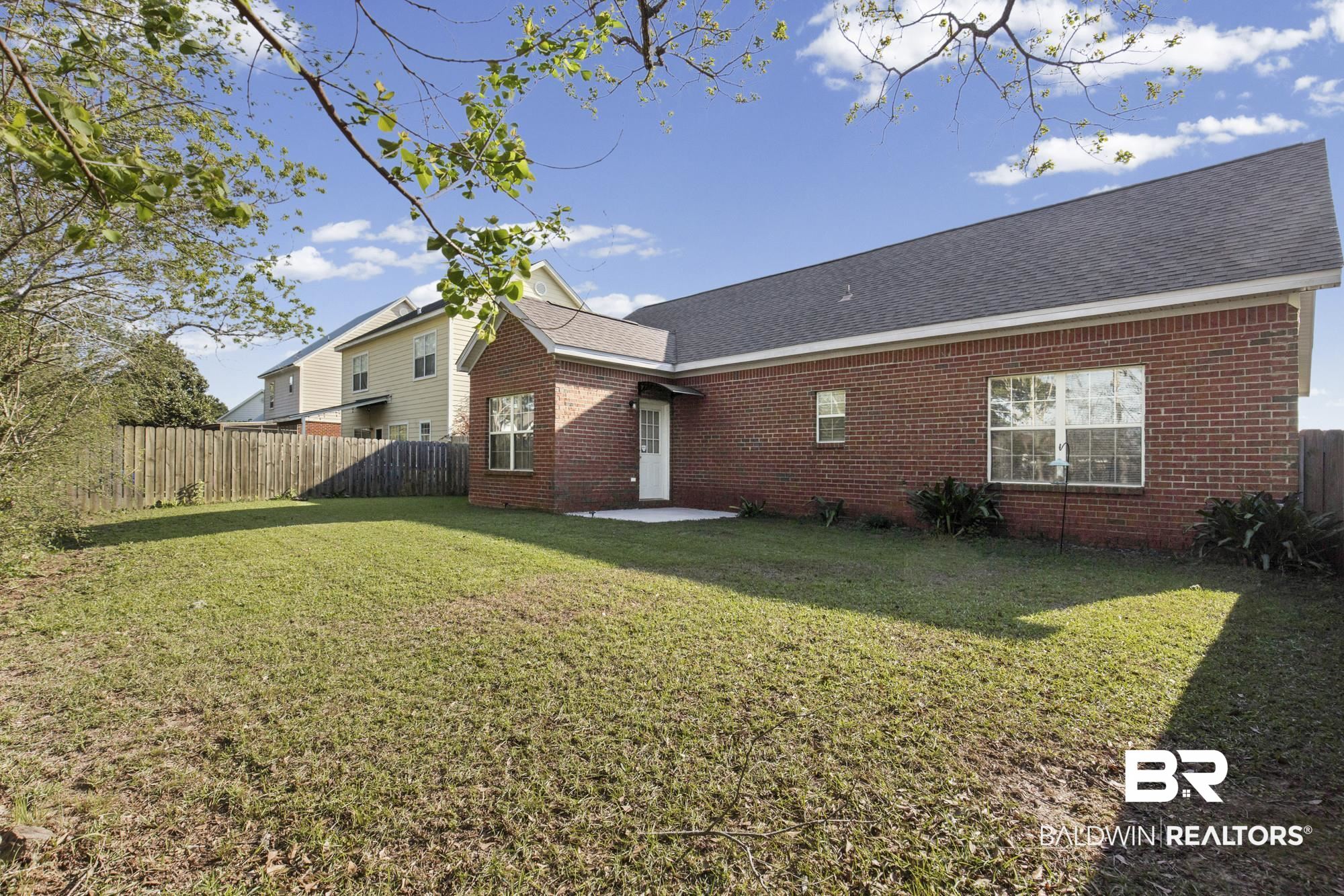1153 Sloane Cove Foley, AL 36535 - Photo 24 of 25 Back of property featuring a patio, brick siding, and a shingled roof