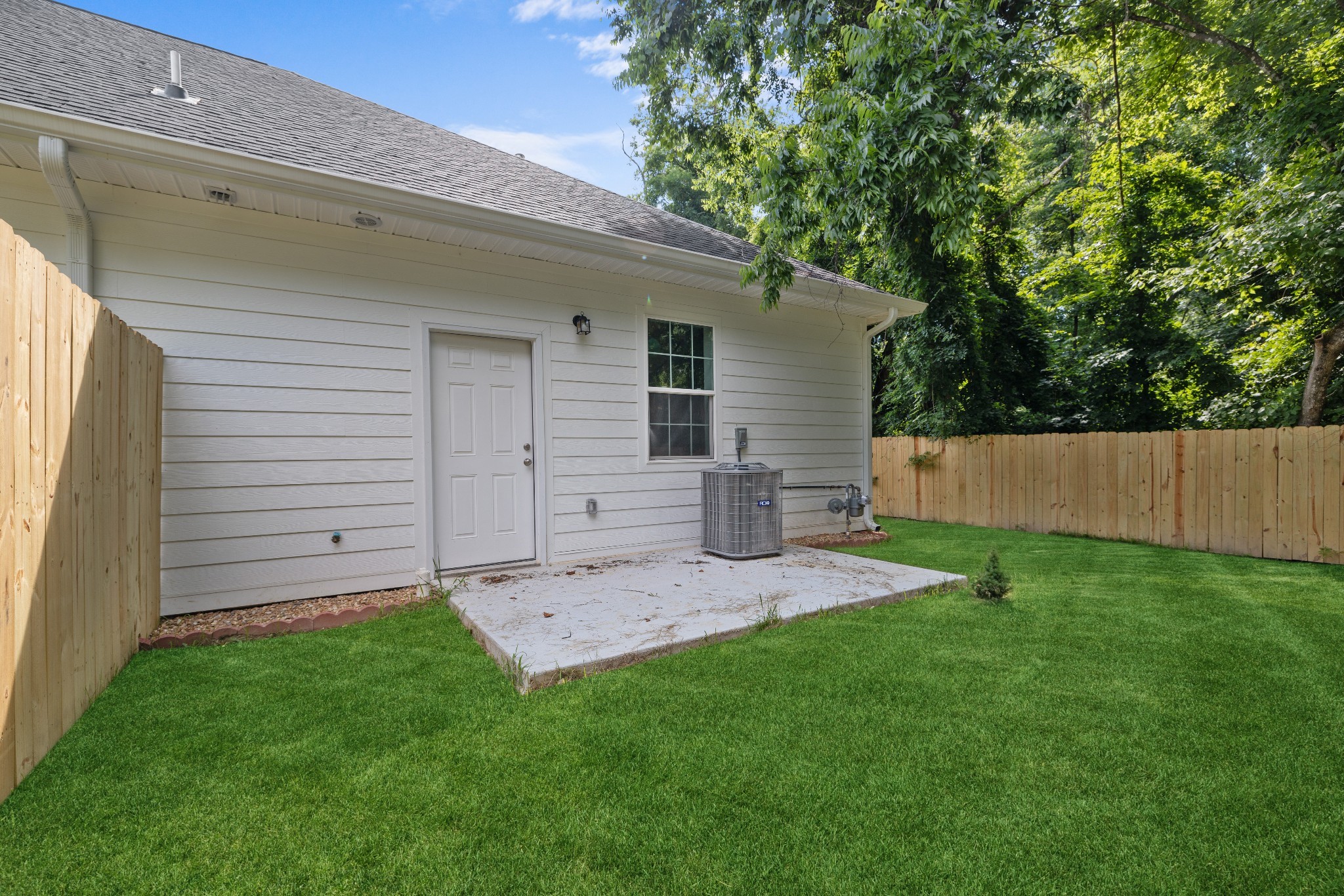115 Freeman Street Tullahoma, TN 37388 - Photo 20 of 27 a view of a backyard with plants and large tree