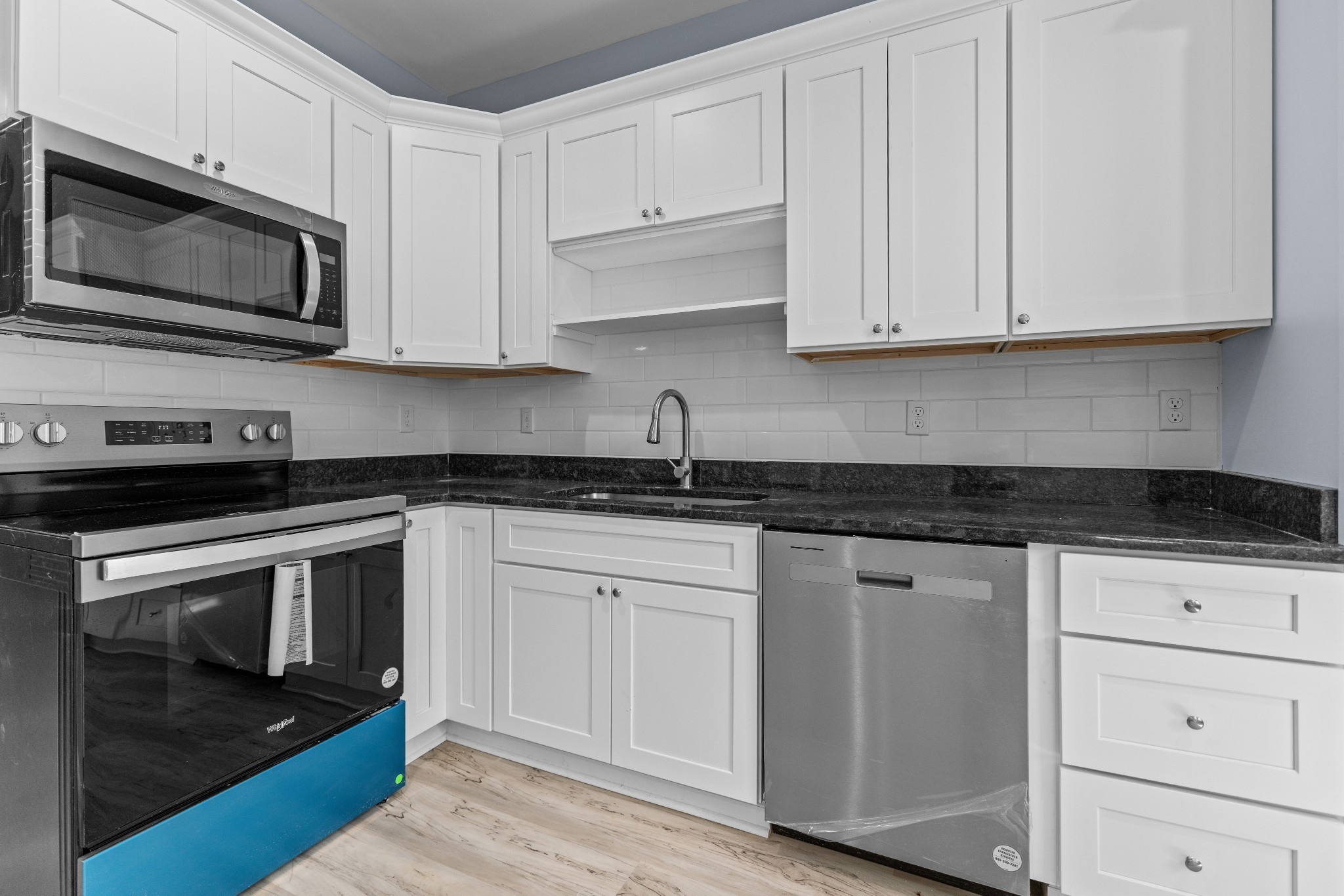 115 Freeman Street Tullahoma, TN 37388 - Photo 9 of 27 a kitchen with granite countertop white cabinets stainless steel appliances and sink