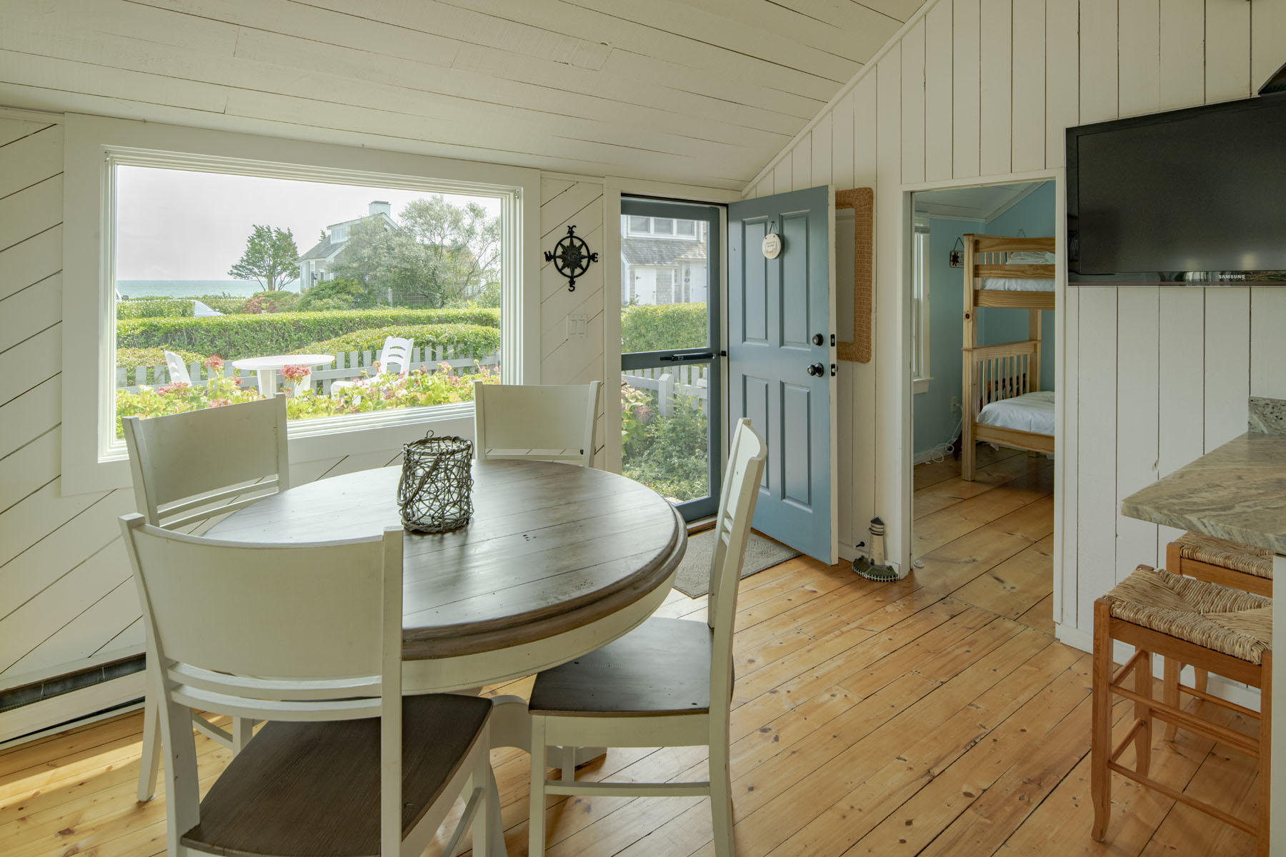 14 Race Point Road Mashpee, MA 02649 - Photo 7 of 18 a dining room with furniture and a floor to ceiling window