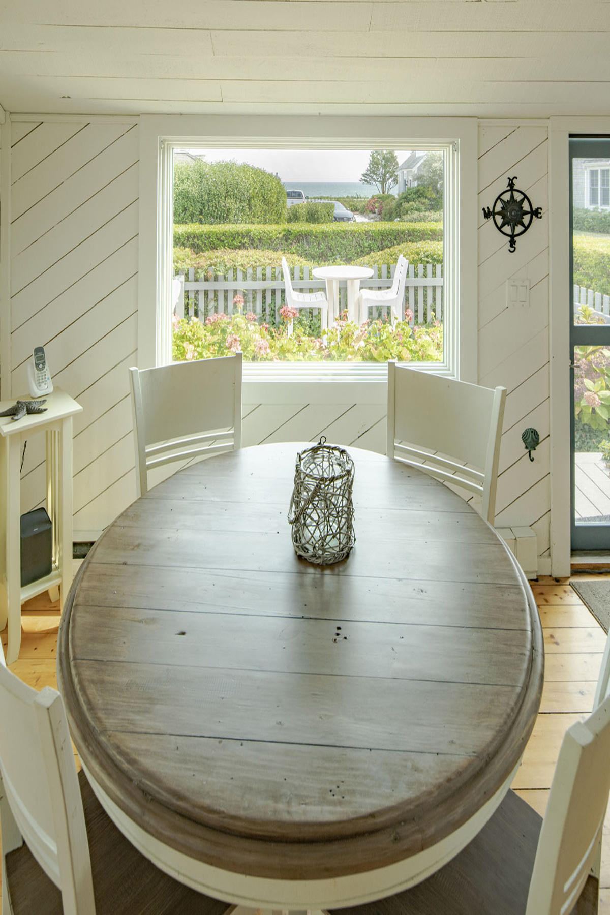 14 Race Point Road Mashpee, MA 02649 - Photo 10 of 18 a view of a living room with a floor to ceiling window and wooden floor
