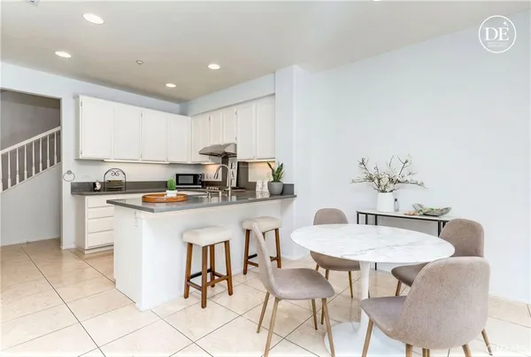 a kitchen with white cabinets and white appliances