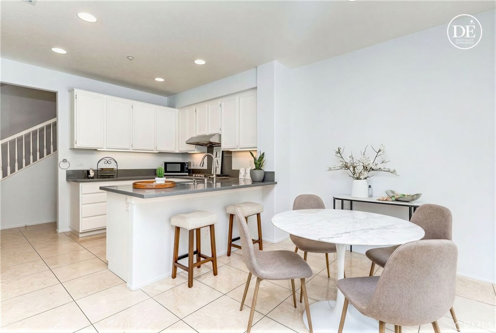 38 Daisy Irvine, CA 92618 - Photo 11 of 41 a kitchen with a dining table chairs and white cabinets