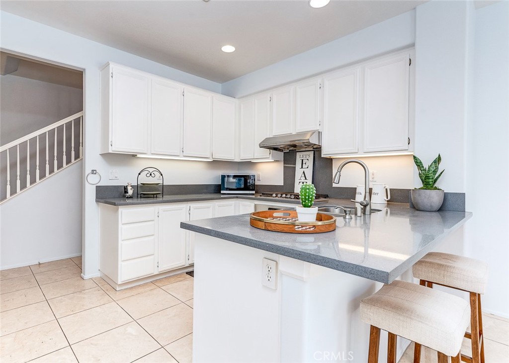 38 Daisy Irvine, CA 92618 - Photo 13 of 41 a kitchen with a sink a stove and white cabinets