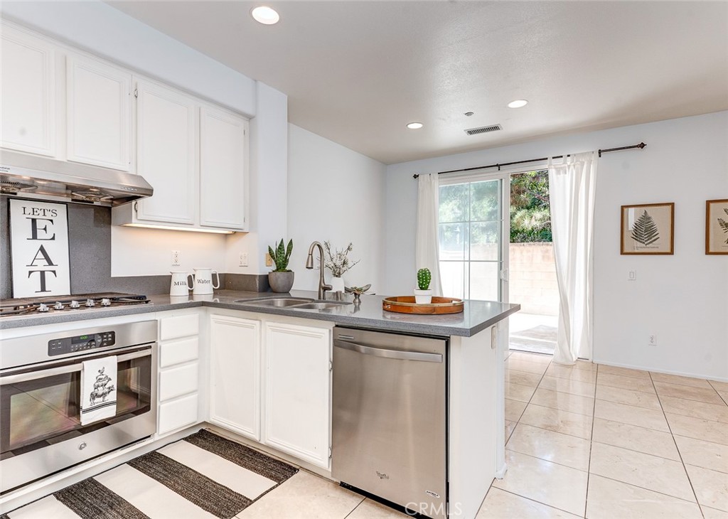 38 Daisy Irvine, CA 92618 - Photo 14 of 41 a kitchen with stainless steel appliances granite countertop a stove a sink and a refrigerator
