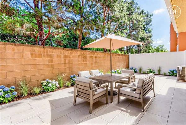 a view of a brick house with potted plants