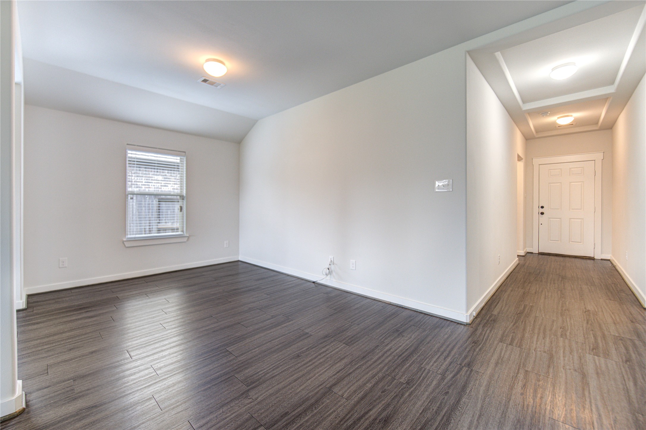 12326 Sabine Point Drive Humble, TX 77346 - Photo 11 of 42 a view of an empty room with wooden floor and a window
