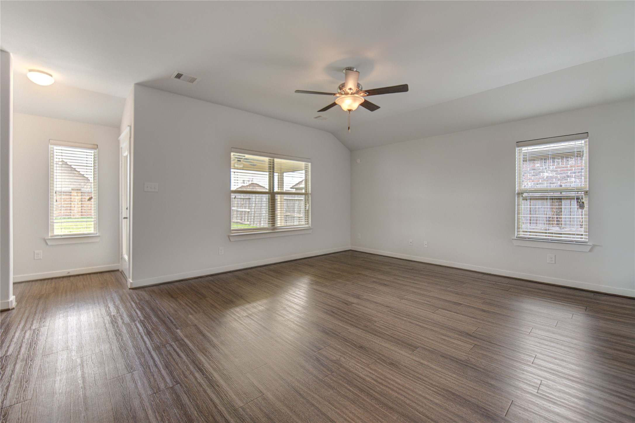 12326 Sabine Point Drive Humble, TX 77346 - Photo 12 of 42 a view of an empty room with wooden floor and a window
