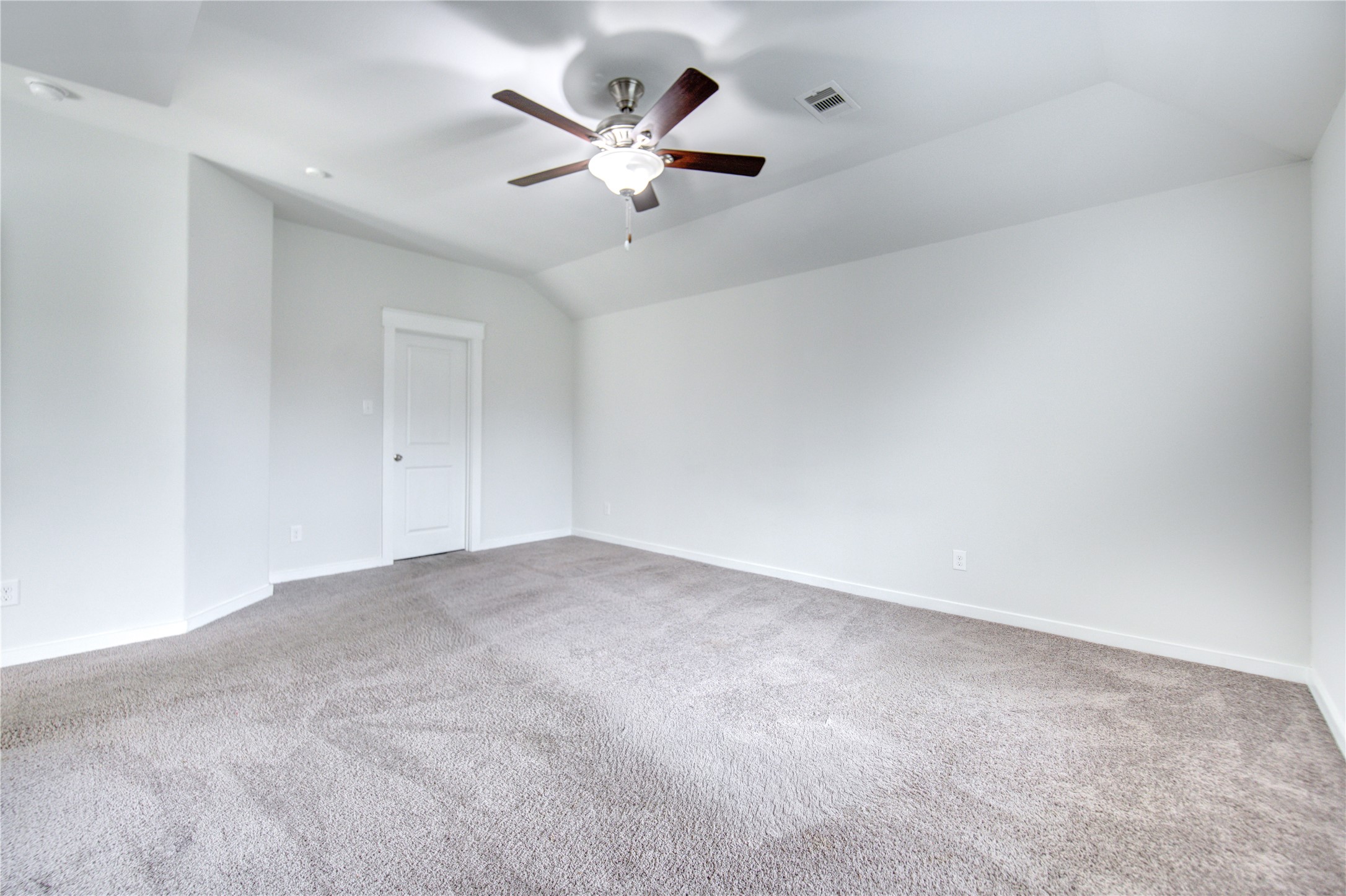 12326 Sabine Point Drive Humble, TX 77346 - Photo 22 of 42 an empty room with a chandelier fan and windows