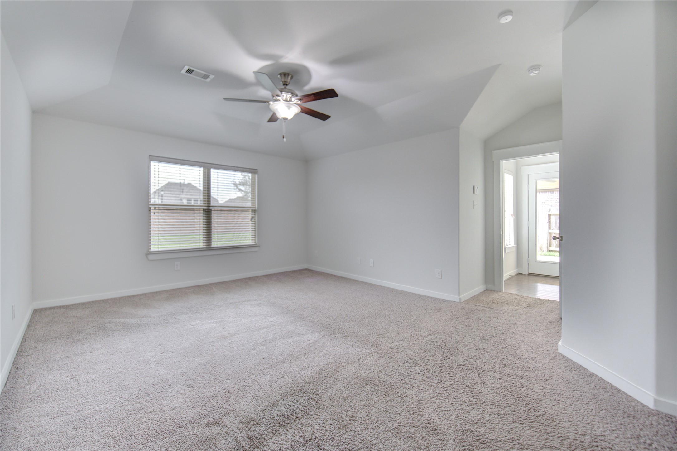 12326 Sabine Point Drive Humble, TX 77346 - Photo 23 of 42 an empty room with windows and ceiling fan