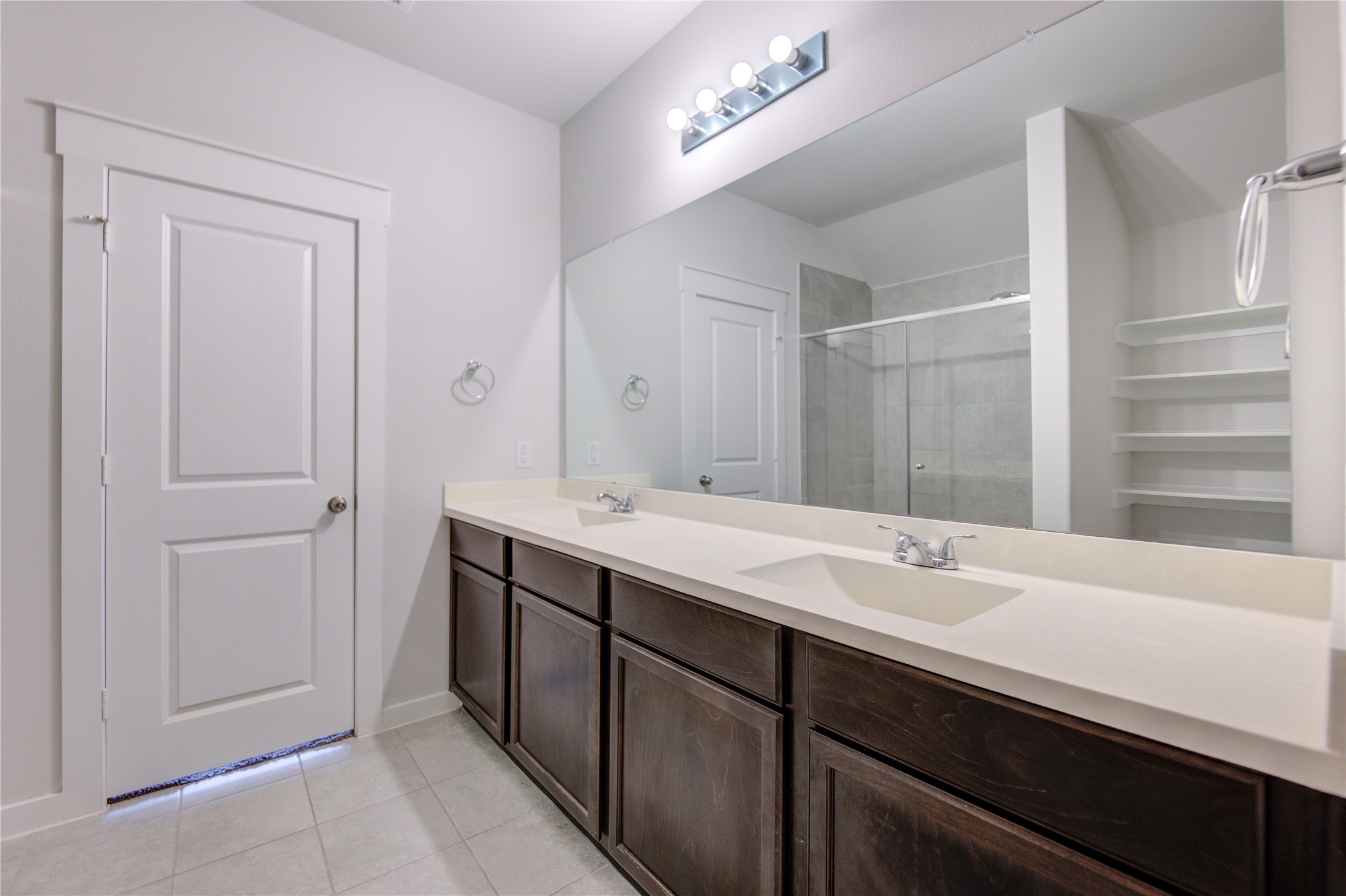 12326 Sabine Point Drive Humble, TX 77346 - Photo 25 of 42 a bathroom with a double vanity sink a mirror and a shower